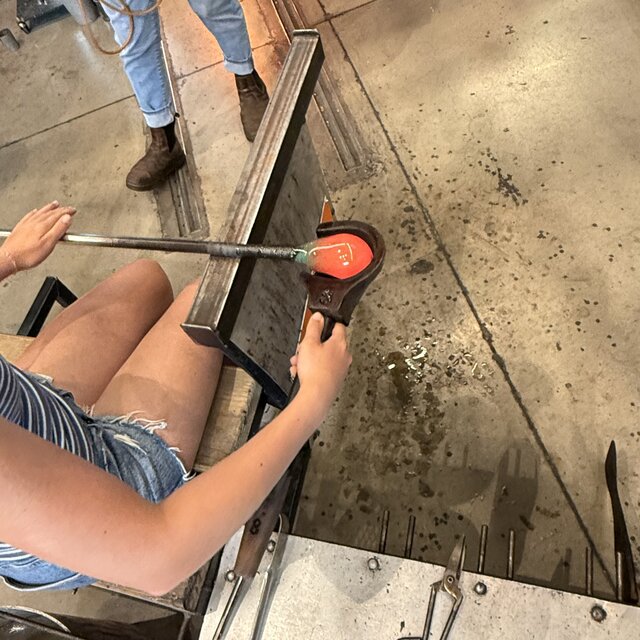 Close-up of blocking molten glass into shape