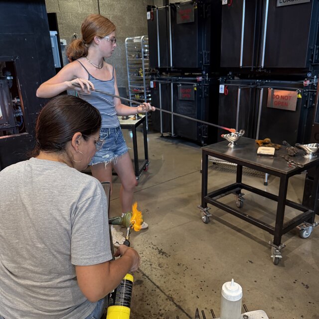 Bringing a bit of glass to the piece at the glory hole