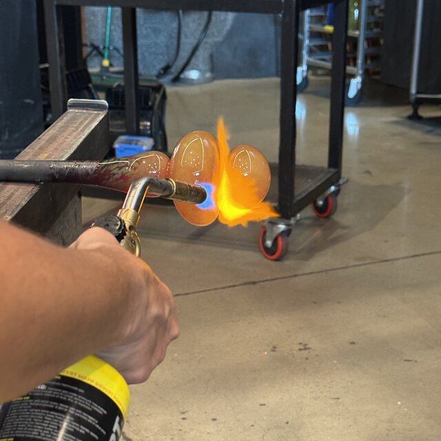 Close-up torching a glass duck sculpture